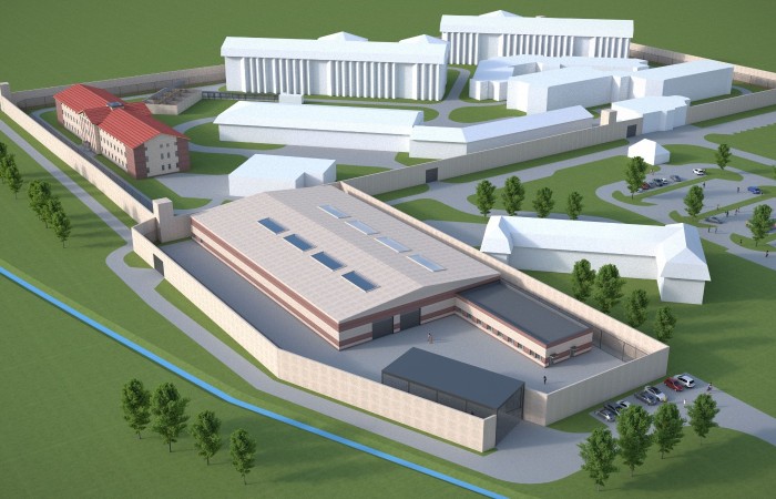 In the photo, Radom penitentiary facility’ visualisation with a group of buildings of different shapes surrounded by the fence and lots of trees and greenery. In the photo, Radom penitentiary facility’ visualisation with a group of buildings of different shapes surrounded by the fence and lots of trees and greenery.