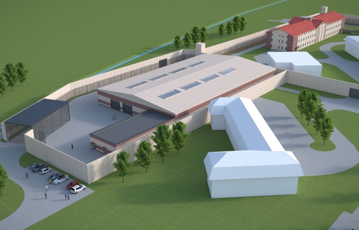 In the photo, Radom penitentiary facility’ visualisation with a group of buildings of different shapes surrounded by the fence and lots of trees and greenery. In the photo, Radom penitentiary facility’ visualisation with a group of buildings of different shapes surrounded by the fence and lots of trees and greenery.