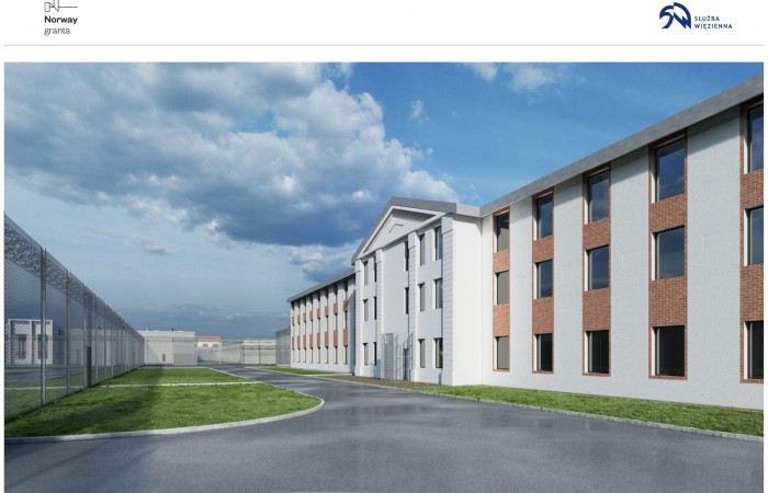 Chmielów penitentiary complex visualisation. In the photo, on the right, a large white building with numerous windows, on the left a barbed-wired fence. Chmielów penitentiary complex visualisation. In the photo, on the right, a large white building with numerous windows, on the left a barbed-wired fence.